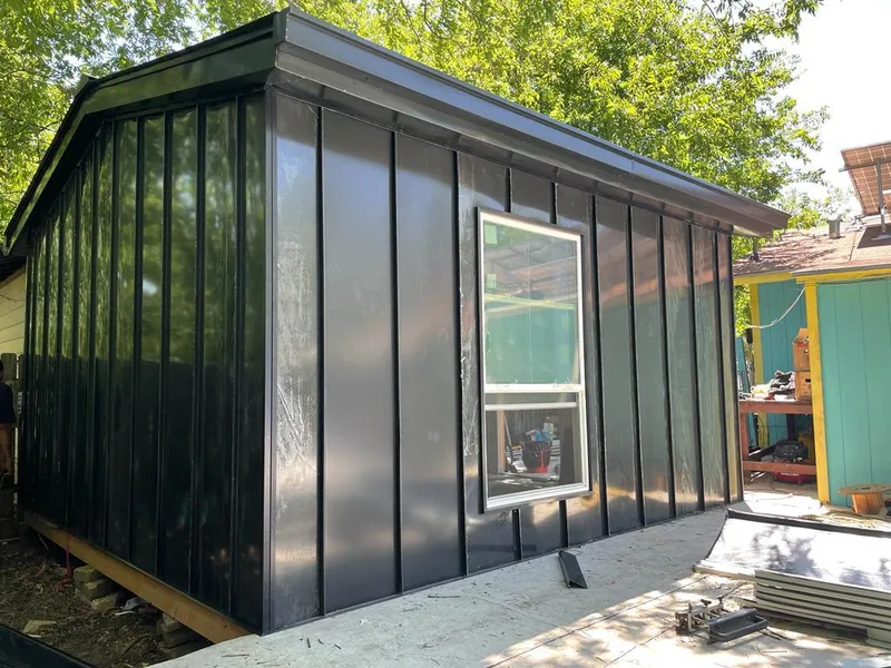 Black standing seam metal wall panels for Metal Roof Installation in Granby